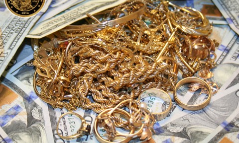 Pile of mixed gold jewelry laying on top of cash in Morton Grove